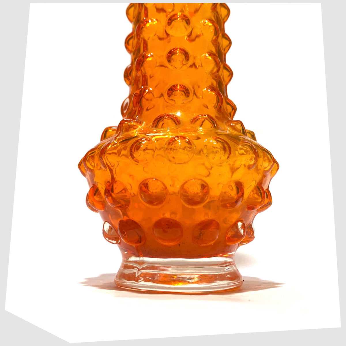 Lower section of the Tajima Japanese Orange Cased Glass Vase with repeating knobbly design, shown on a white background