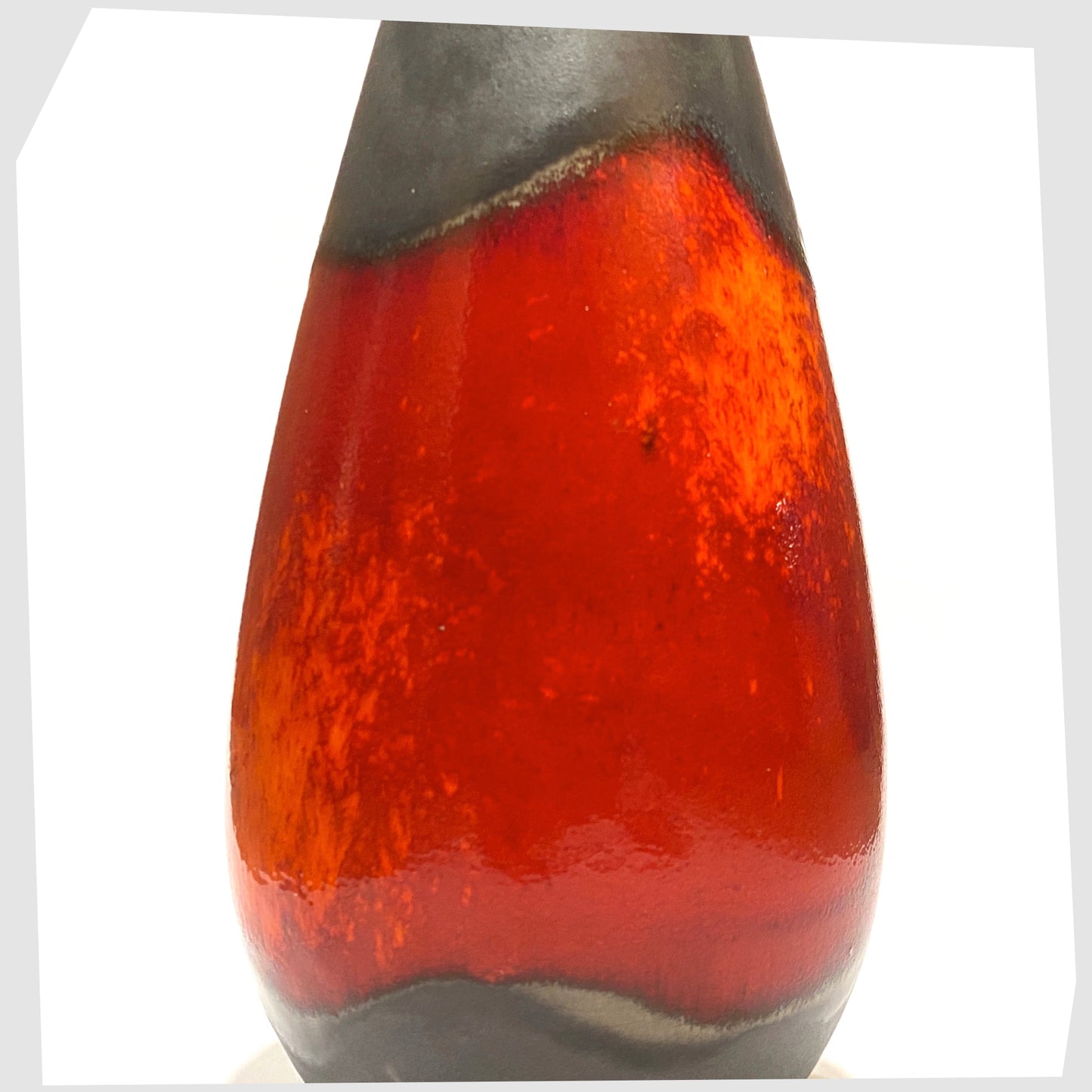Close up of the U-Keramik 455/20 Vase in matte grey glaze with a central band of fiery red and volcanic orange, shown on a white background