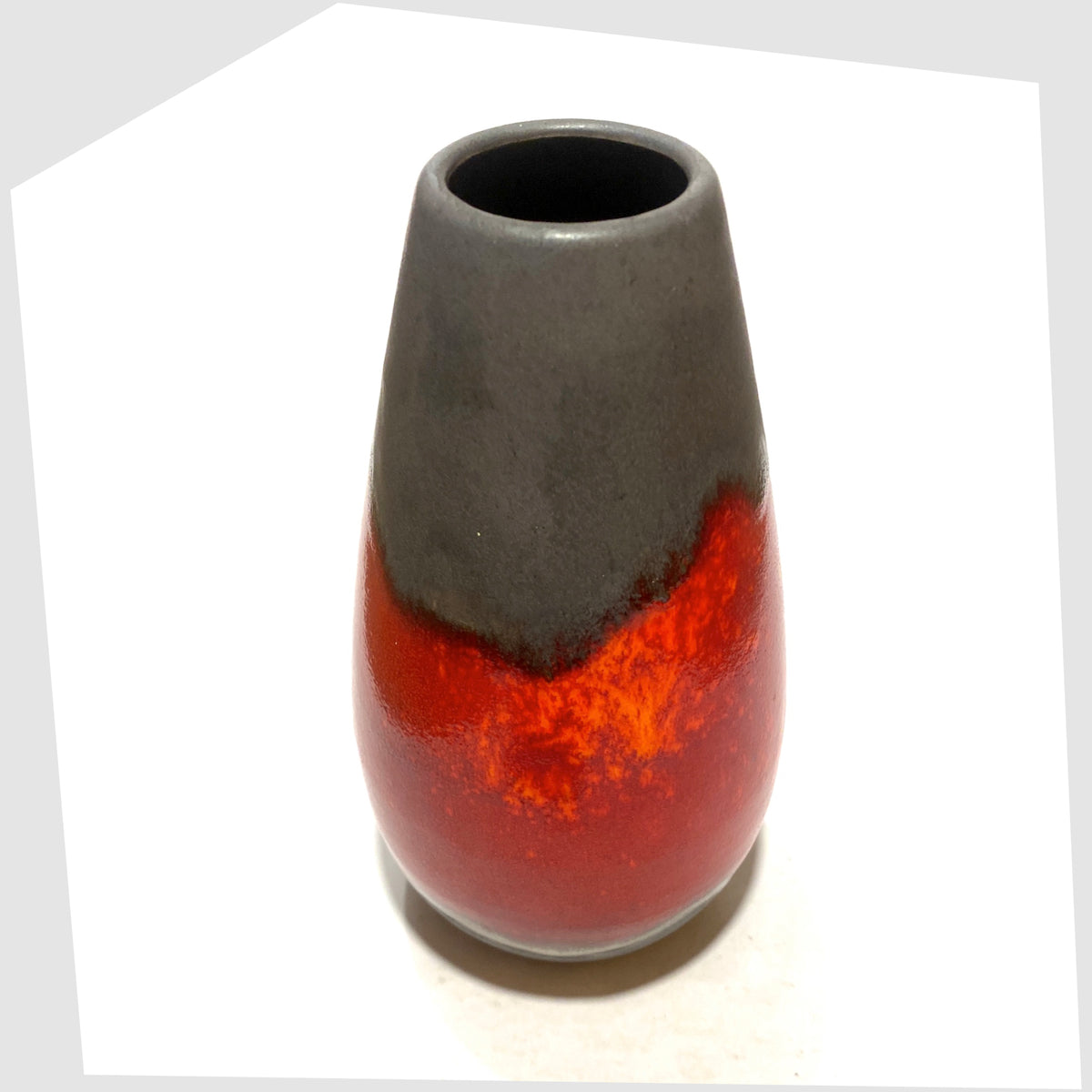 Top rim of the U-Keramik 455/20 Vase in matte grey glaze with a central band of fiery red and volcanic orange, shown on a white background
