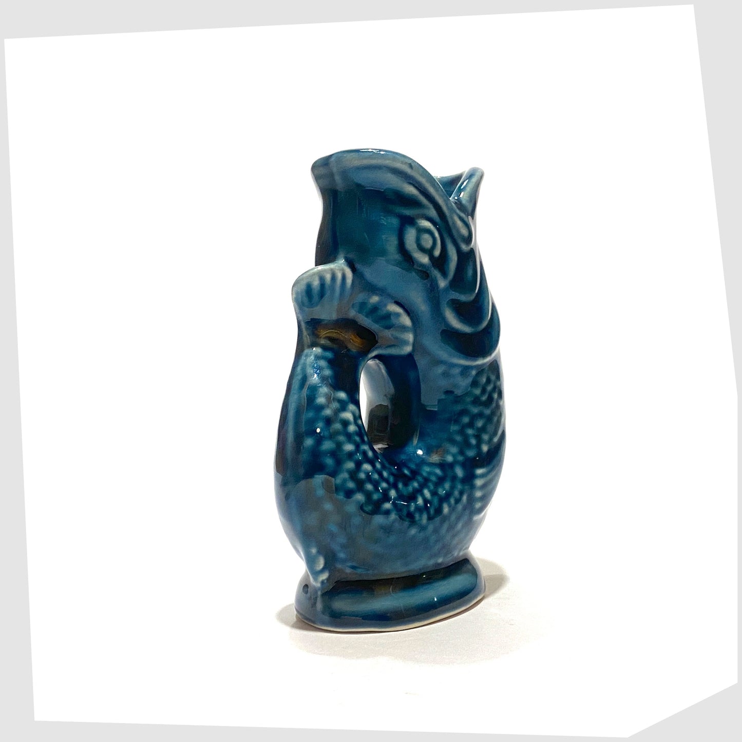 vintage fish-shaped miniature Dartmouth Pottery Gluggle Jug finished in a teal blue glaze