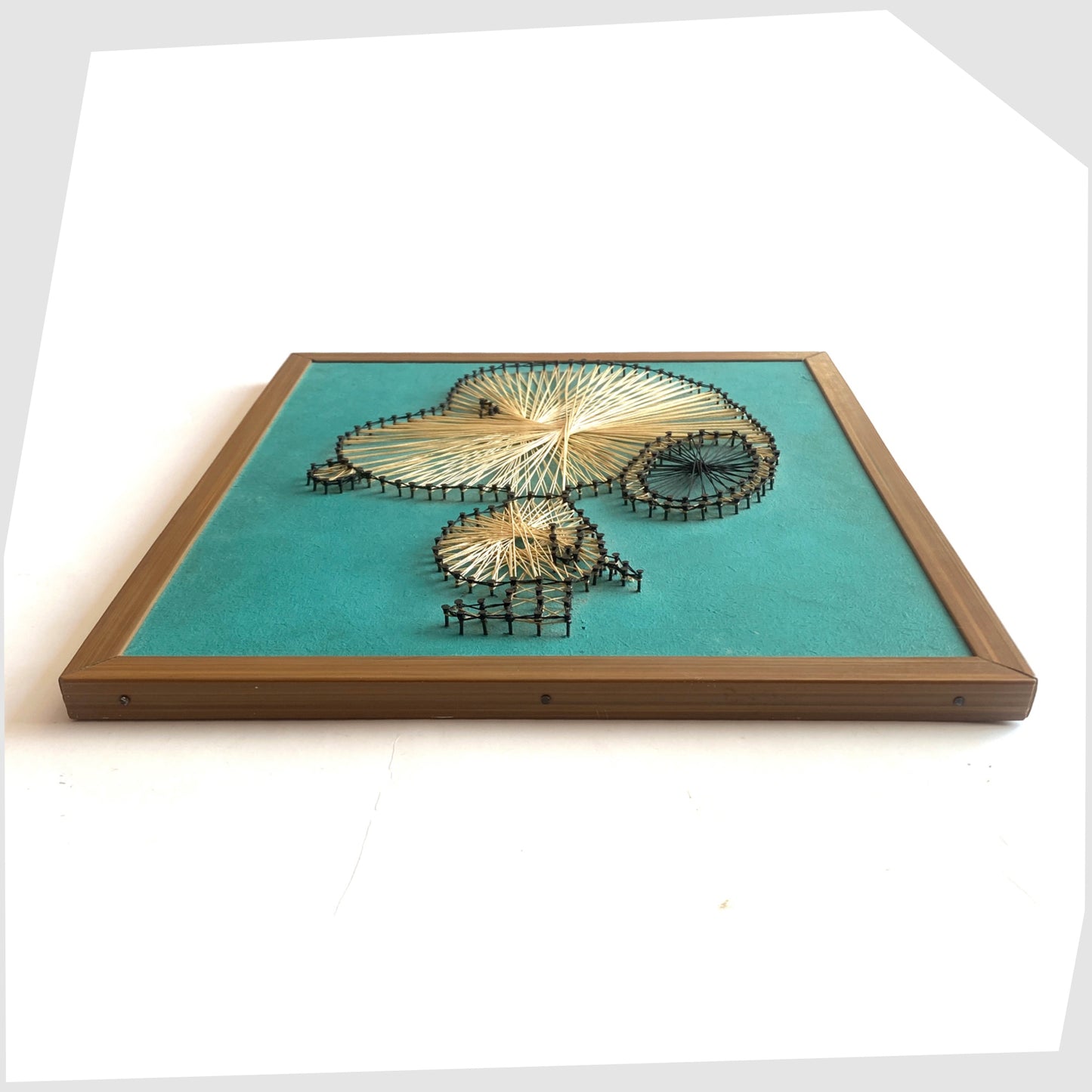 Side profile of the Vintage Snoopy String Artwork, created from beige string and black nails on a teal background, shown on a white background