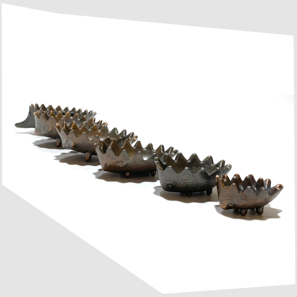 Walter Bosse style Hedgehog Ashtray Set, shown unstacked on a white background