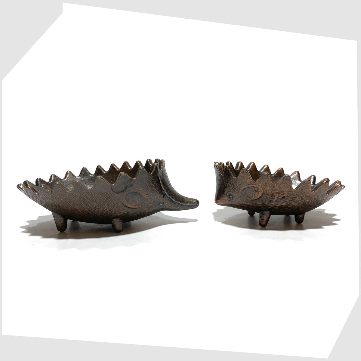 Walter Bosse style Hedgehog Ashtray Set, two sizes shown unstacked on a white background