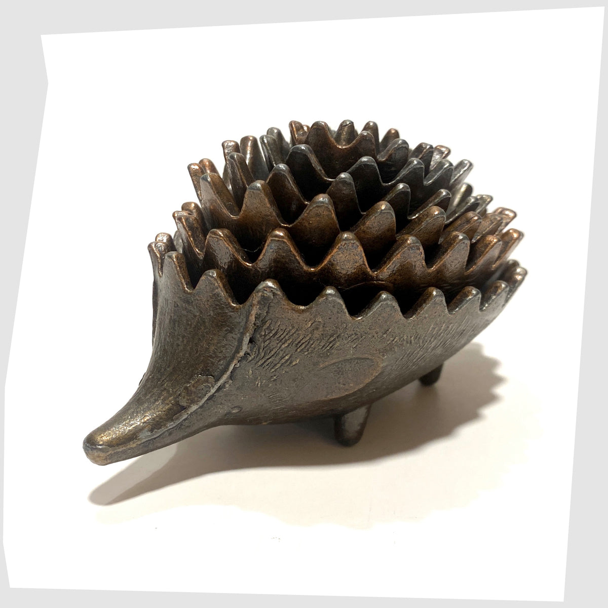 Walter Bosse style Hedgehog Ashtray Set made of bronzed alloy , shown stacked on a white background