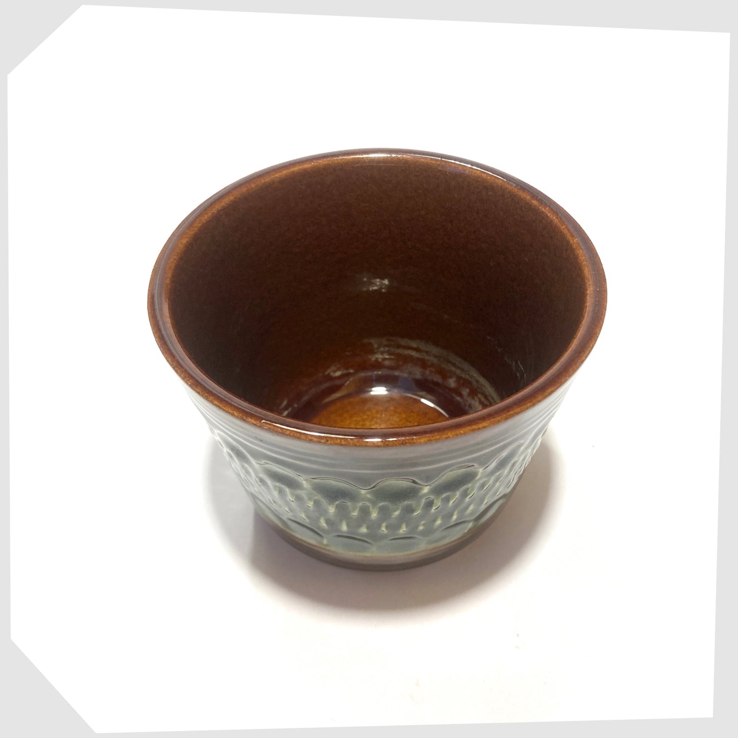 inside of the bay keramik 44-12 planter featuring a textured chestnut brown base with green central band
