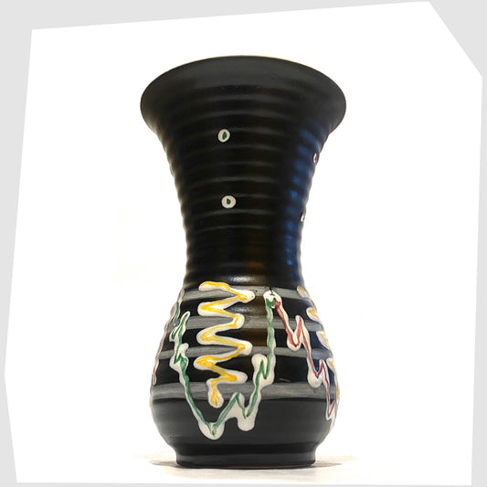 Black West German Pottery Vase with artistic lines of yellow, green and red glaze, shown on a white background