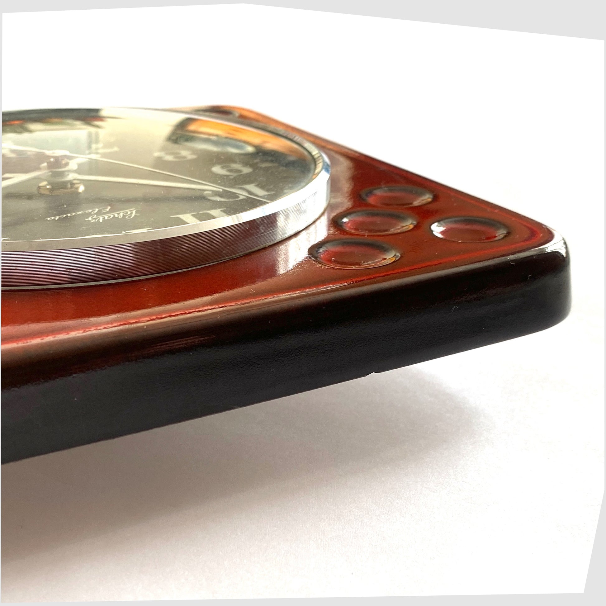 side profile of the west german pottery wall clock made of rich red ceramic with black and white dial