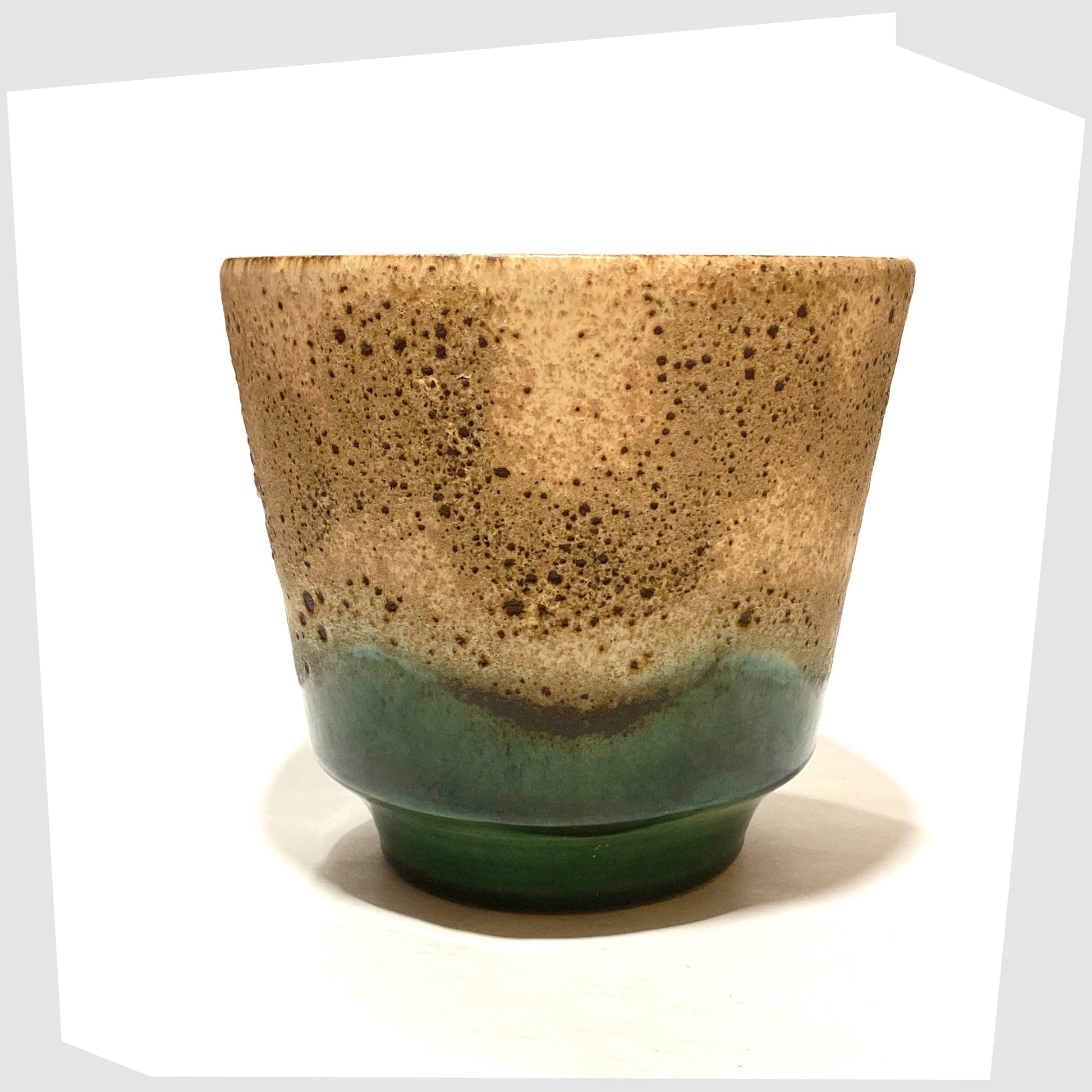 1970s West German Pottery Plant Pot finished in green glaze with cascading matte fat lava glaze, shown on a white background