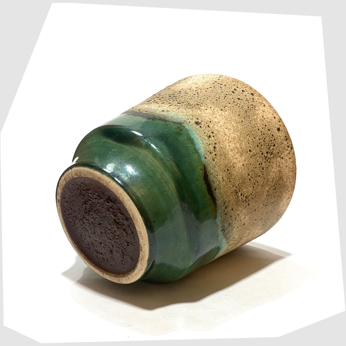 base of the West German Pottery Planter finished in green glaze with cascading matte fat lava glaze, shown on a white background