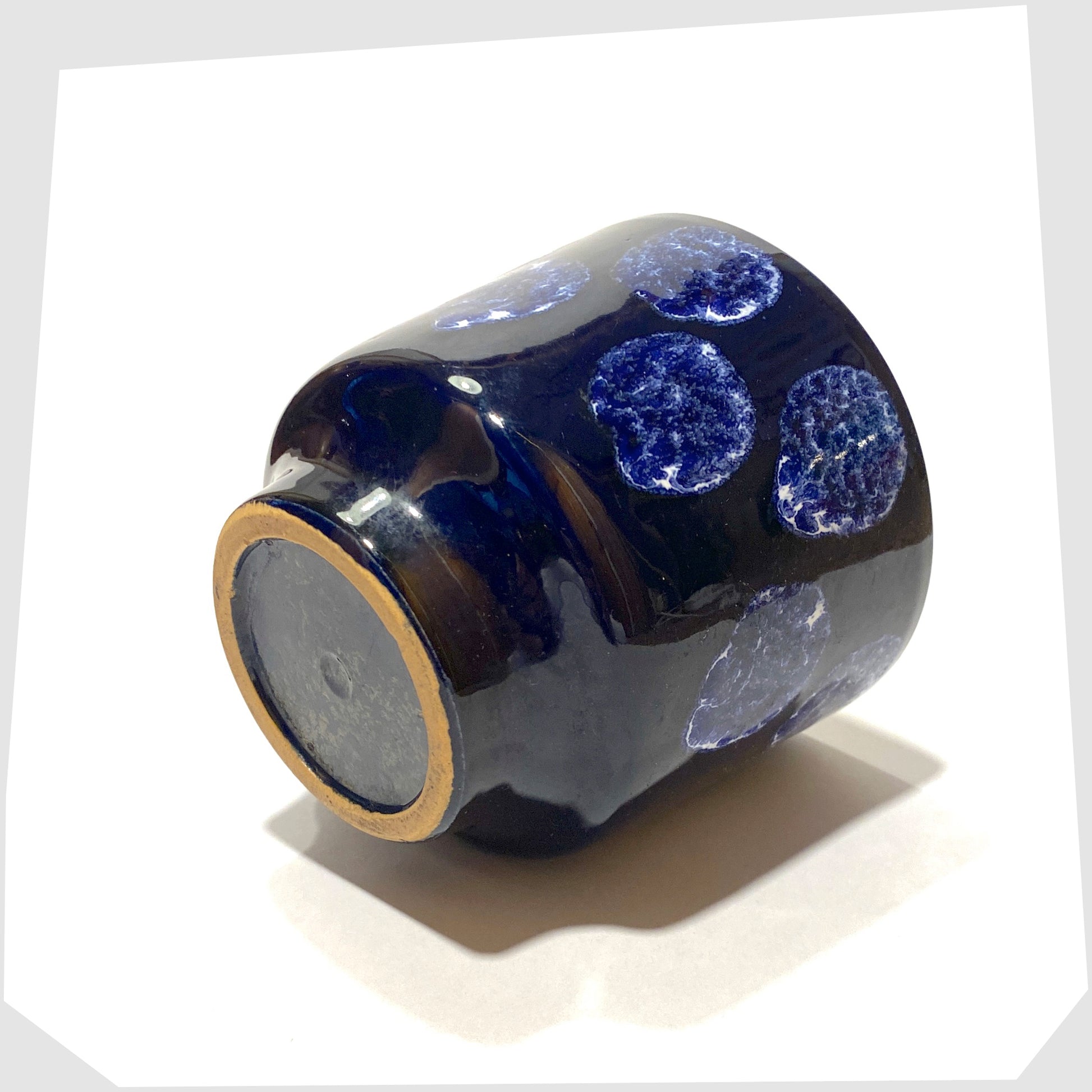 base of the vintage navy blue planter with white drip glaze spots