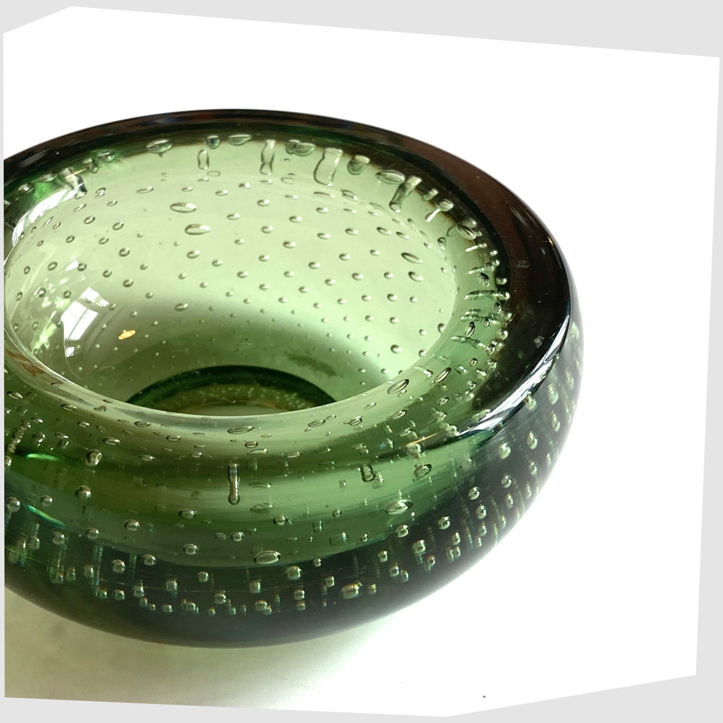 Close up of the Whitefriars Controlled Bubble Dish in Green Glass