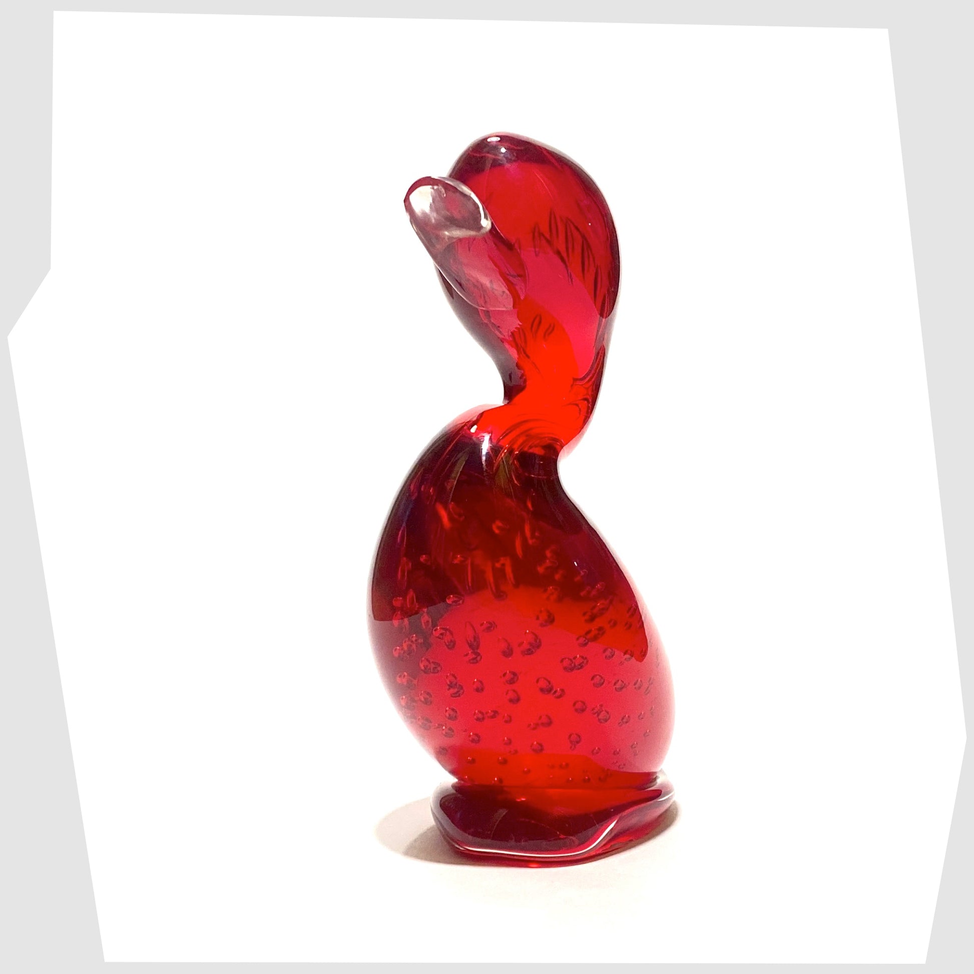 front of the whitefriars glass dilly duck ornament in ruby red glass with controlled bubbles