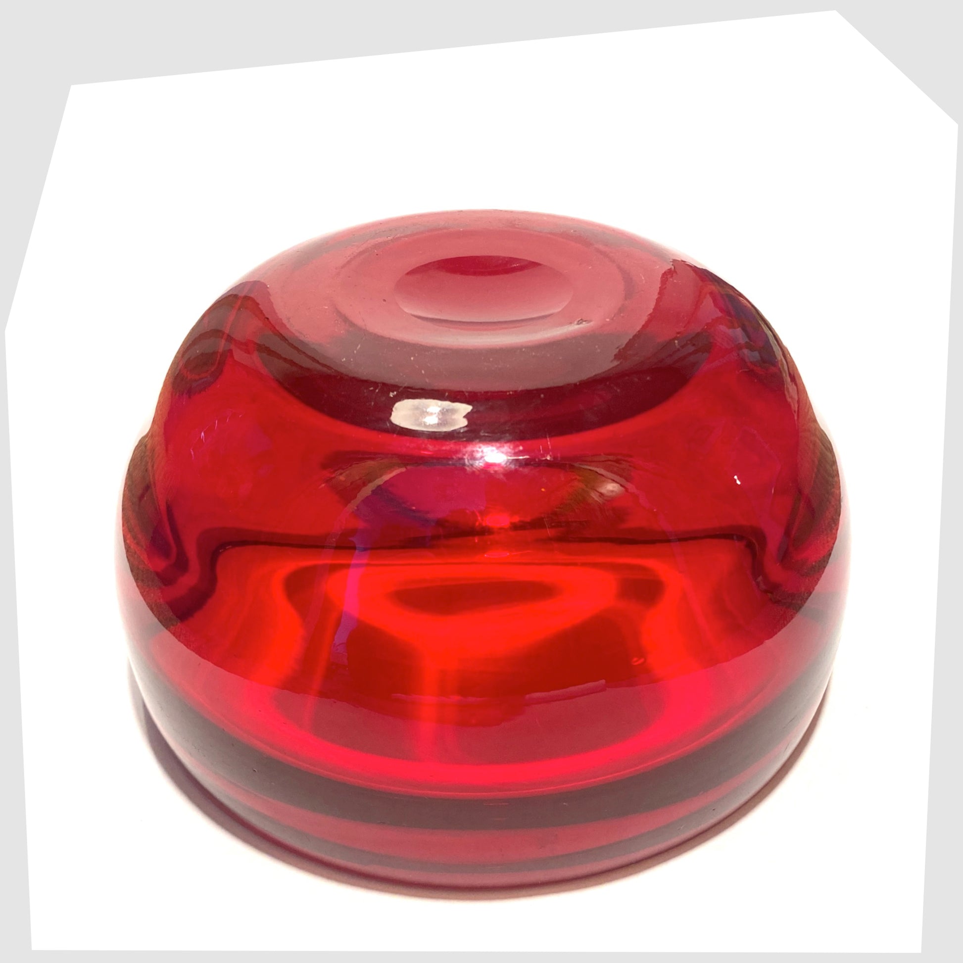 Base of the Whitefriars Glass Optical Bowl in ruby red glass, shown on a white background
