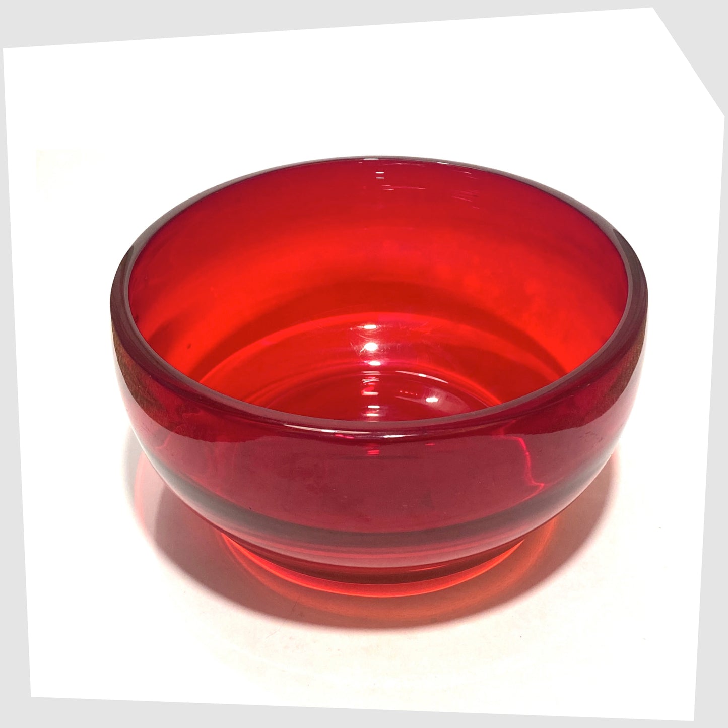 Top rim of the Whitefriars Glass Optical Bowl in ruby red glass, shown on a white background