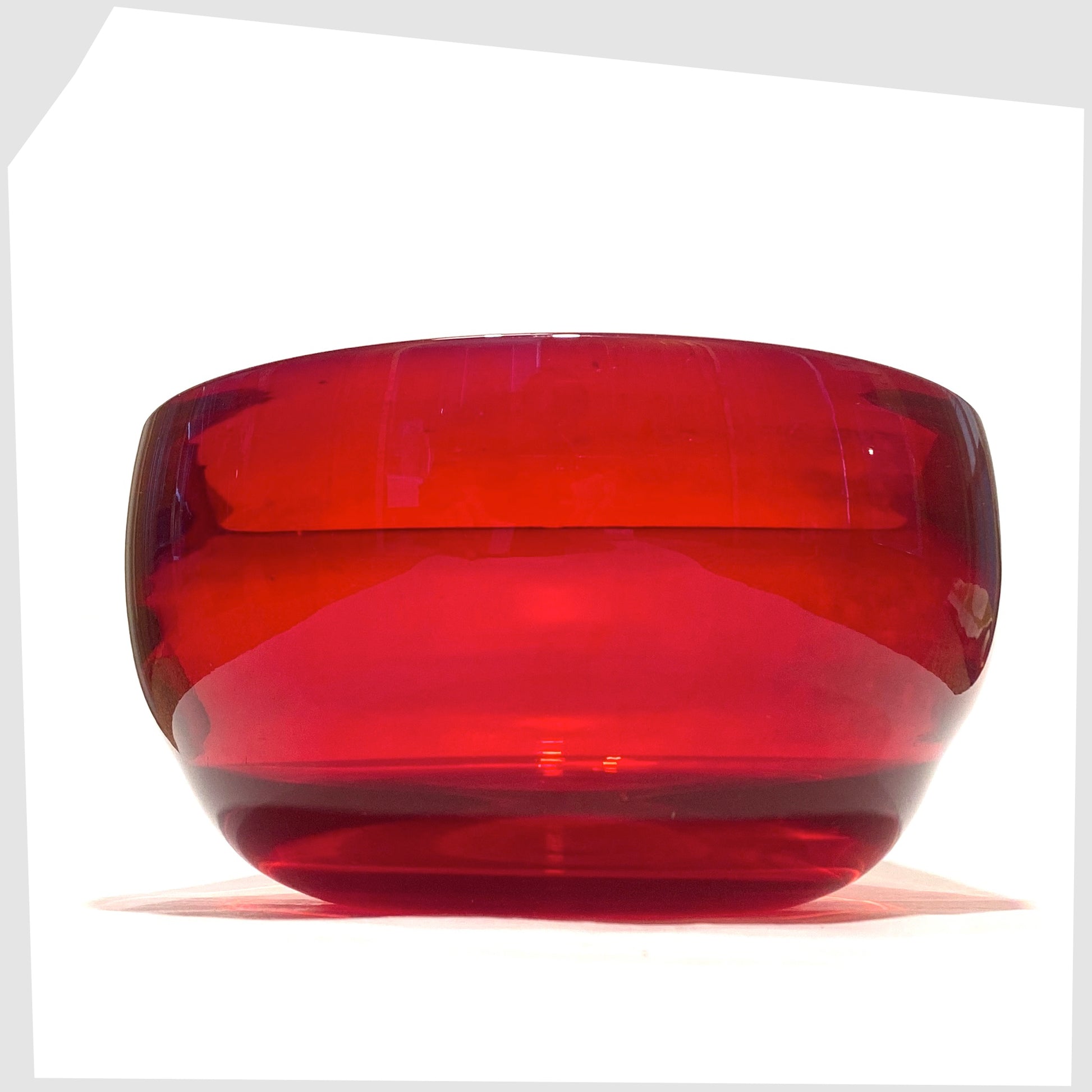 1960s Whitefriars Glass Optical Bowl in ruby red glass, shown on a white background