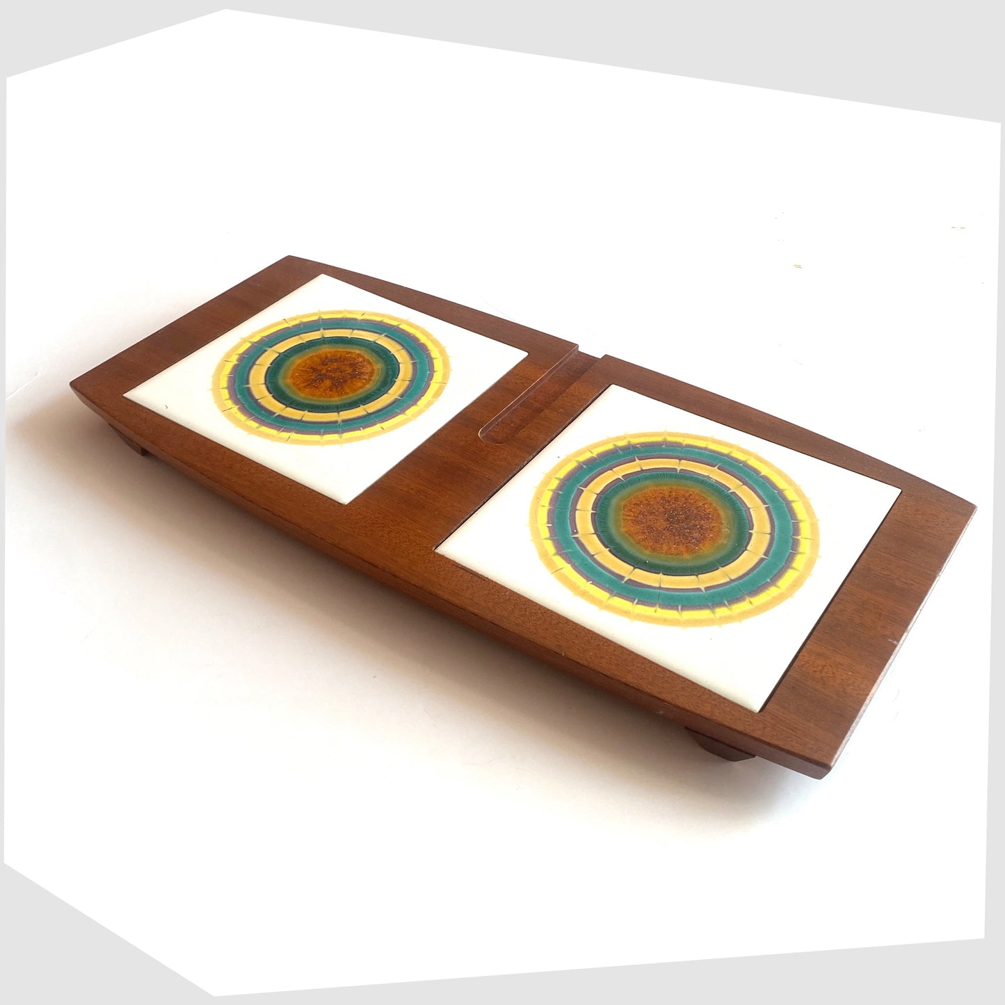 Side profile of the Wyncraft Serving Tray made of teak woodd with matching pair of Alan Wallwork Ceramic Tiles with a radial design, shown on a white background