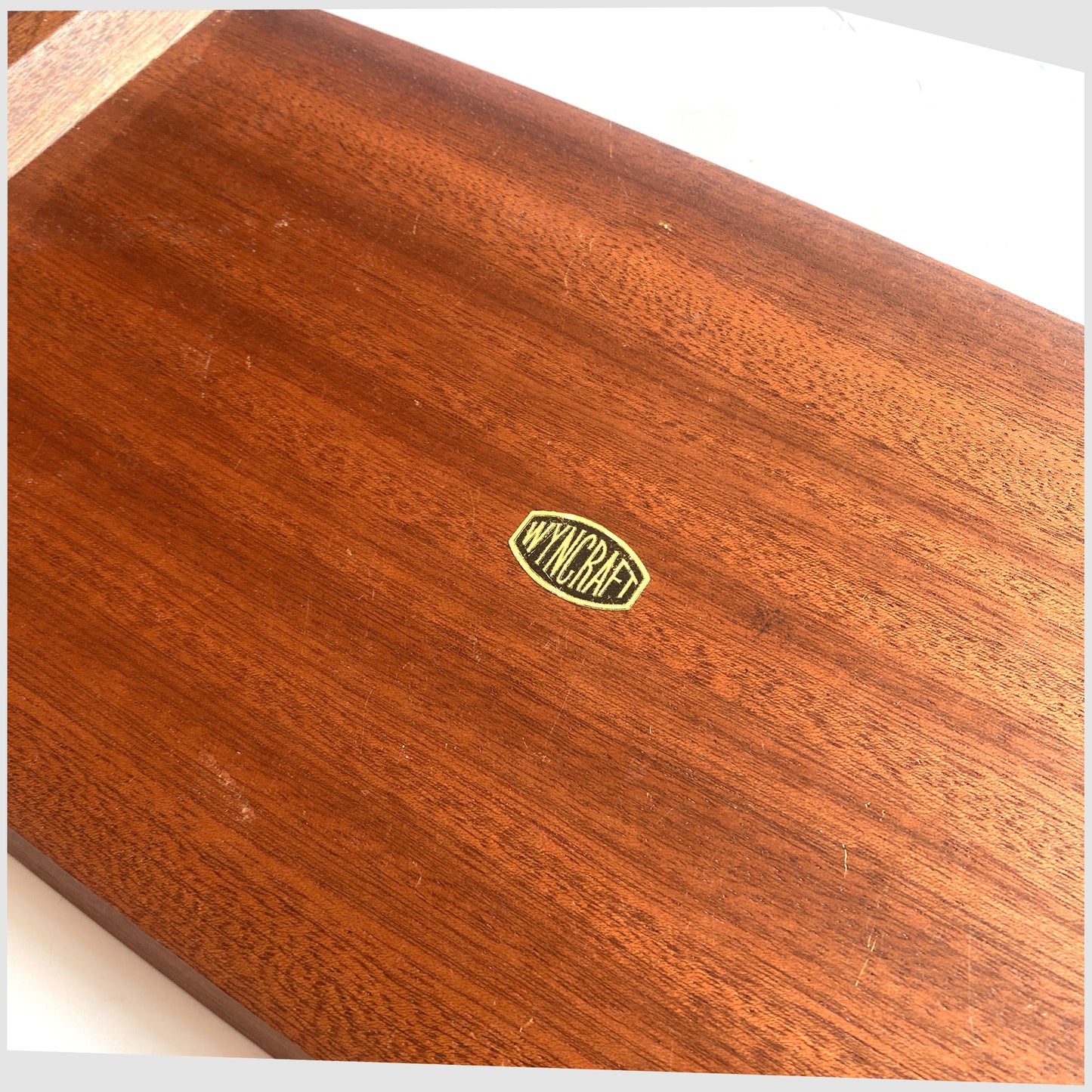 Close up of the original label on the base of the Wyncraft Serving Tray made of teak woodd with matching pair of Alan Wallwork Ceramic Tiles,