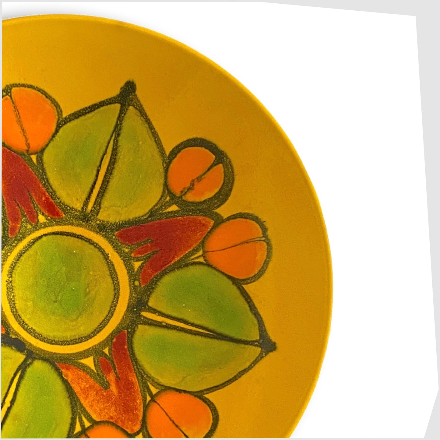 detail of the delphis glazing in mustard yellow, green and oranges on the poole pottery dish, shape 4
